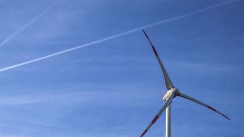 Rotor blades of wind turbine against blue sky