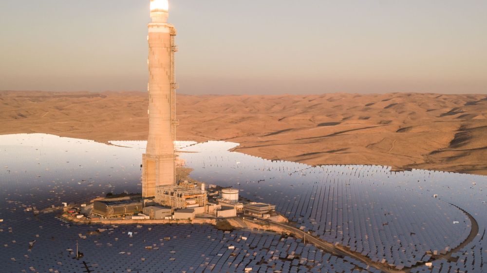 Auf dem Bild ist ein solarthermisches Turm-Kraftwerk in der Wüste zu sehen.