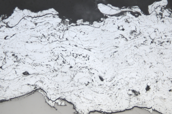 Section through a sprayed layer of the new zinc-aluminium alloy, light microscope image.